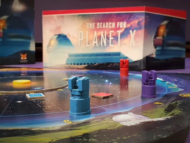 The Search for Planet X board game with pieces and box visible in the background.