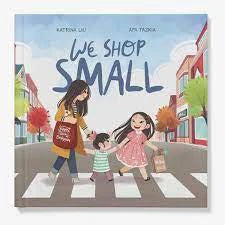 We Shop Small book cover featuring a woman and two children crossing a street.