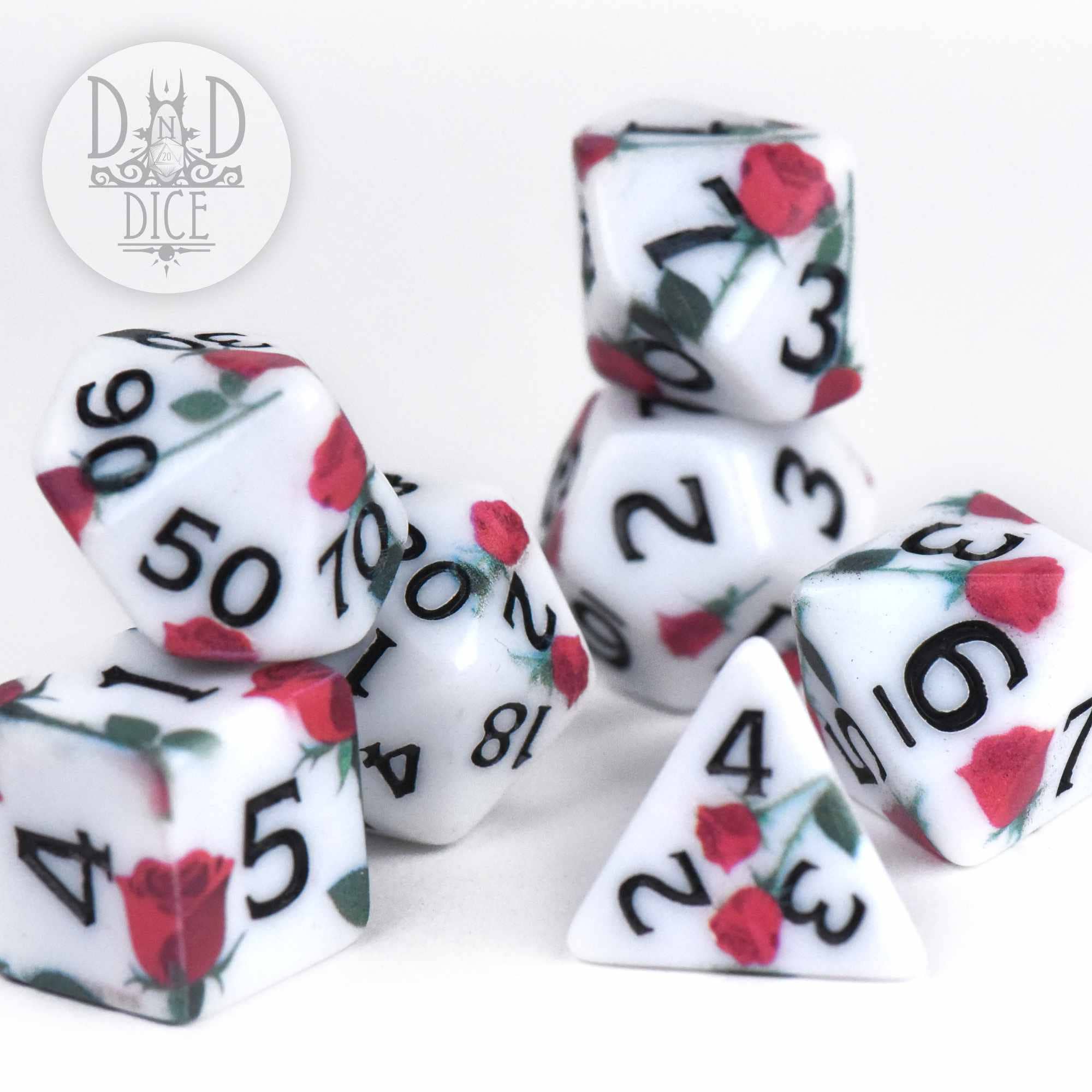 White acrylic dice set featuring red rose designs and black numbers.