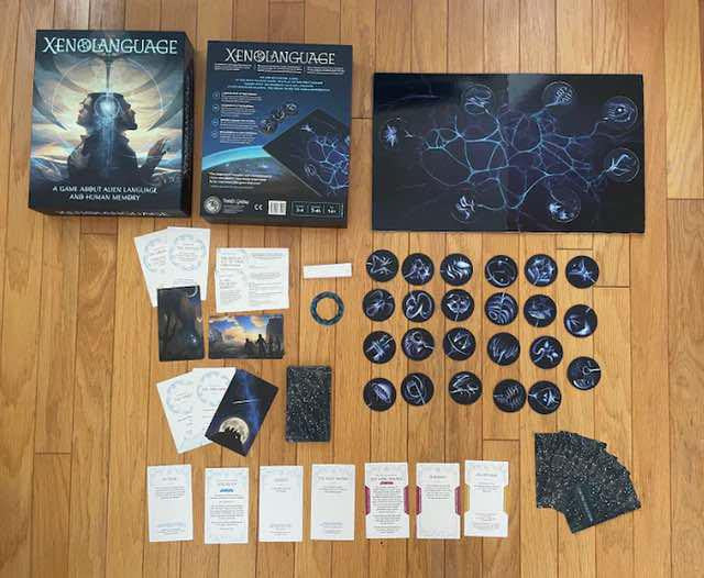 Xenolanguage: A Game About Alien Language and Human Memory board, cards, and tokens on a wooden floor.