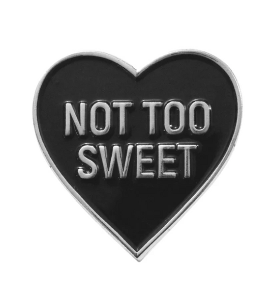 Not Too Sweet Heart Pin in polished silver with bold lettering and sleek silver edges on a shiny heart shape.