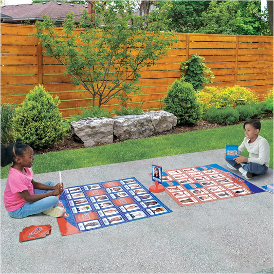 Two children playing Guess Who Giant Edition Game outdoors.