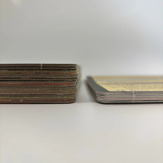 Two stacks of Root: Cardstock Faction Board Pack boards on a white surface.