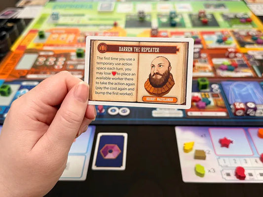 Euphoria Essential Edition board game with a hand holding a game card above the board.