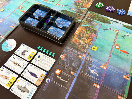 Finspan: Sharks & Reefs Expansion with fish cards, tokens, fish meeples, and ocean-themed game board.