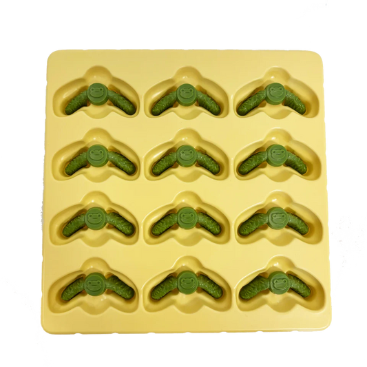 Yellow silicone mold with 12 smiling green frog shapes inspired by Root: Deluxe Frog Clearing Markers.