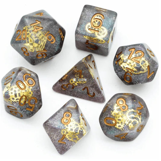 Glitter Gearwheel RPG Dice Set with seven translucent dice featuring gold numbers and foil.