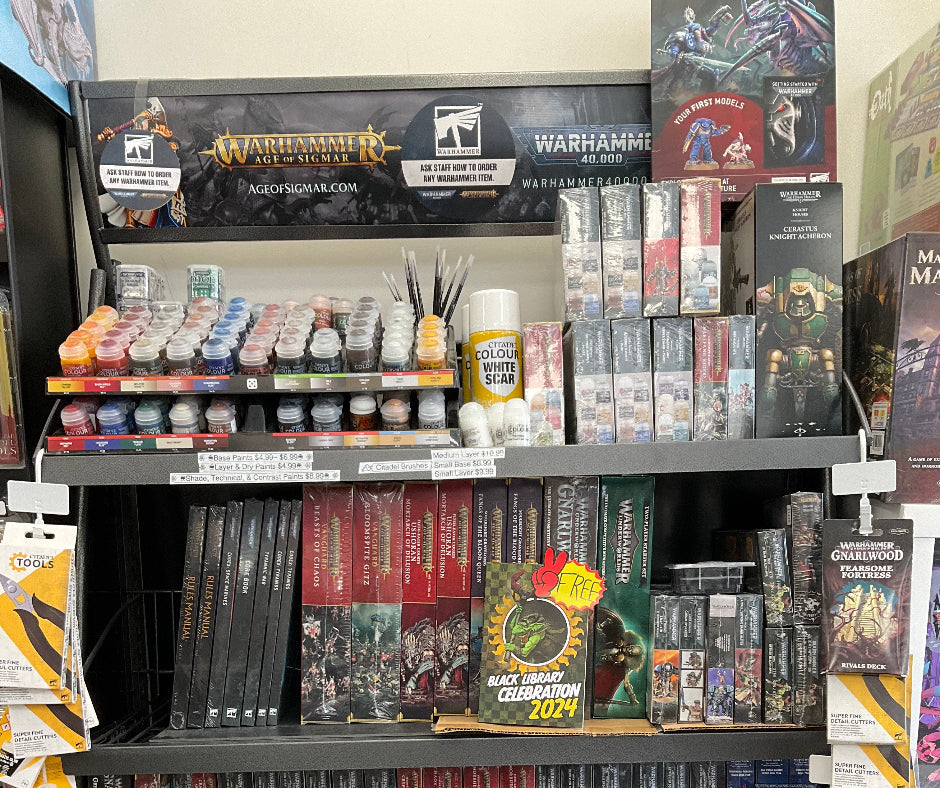 Display of Warhammer game boxes and accessories in a store