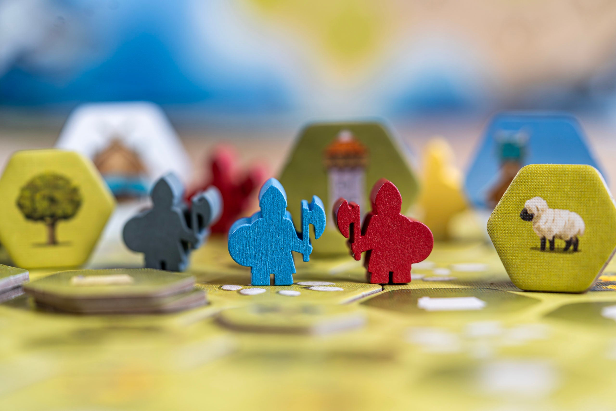 Looot Viking strategy game components: colorful pieces, hex tiles, trees, and sheep.