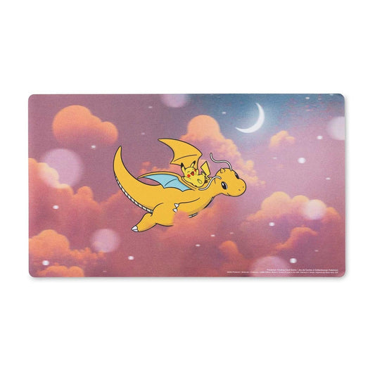 Pokémon TCG: Dreamy Dragonite Playmat featuring Pikachu riding Dragonite through a pink sky.