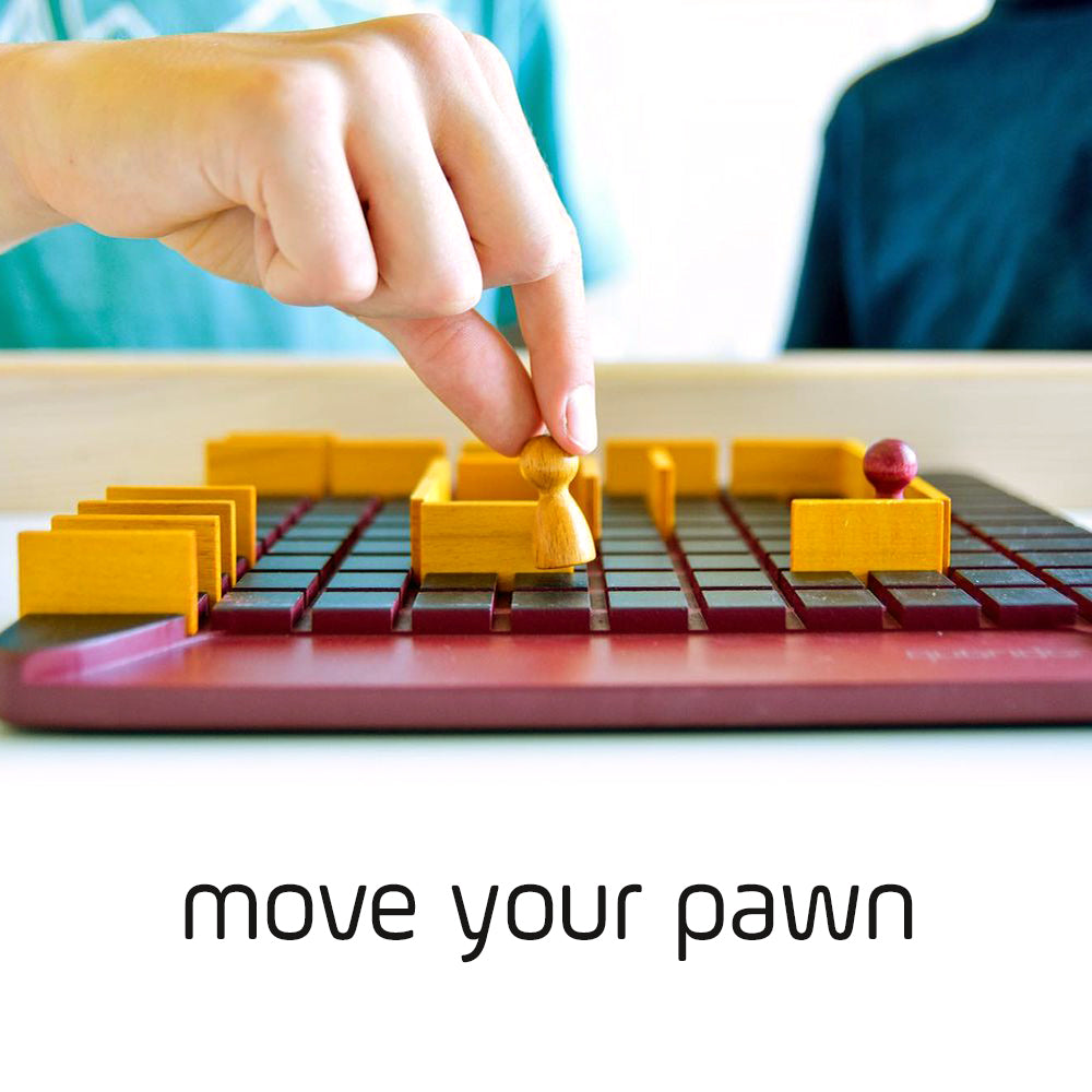 Wooden pawn being moved on a Quoridor game board, with visible text below reading move your pawn.