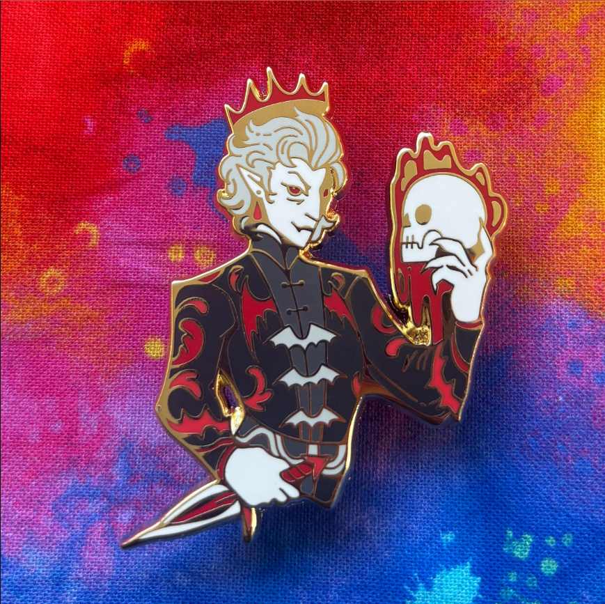 Astarion - Dual Destinies Pin featuring regal, fanged character with skull; red and blue fantasy background.
