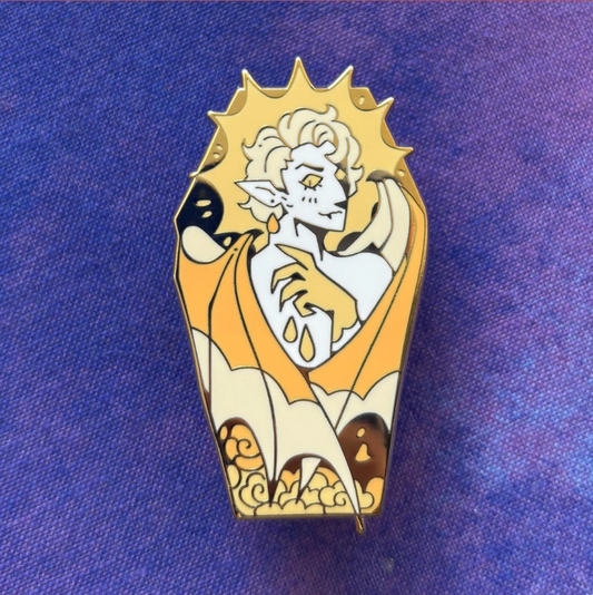 Coffin Pin: Fantasy elf enamel pin with white hair, yellow cape, and sunburst design.