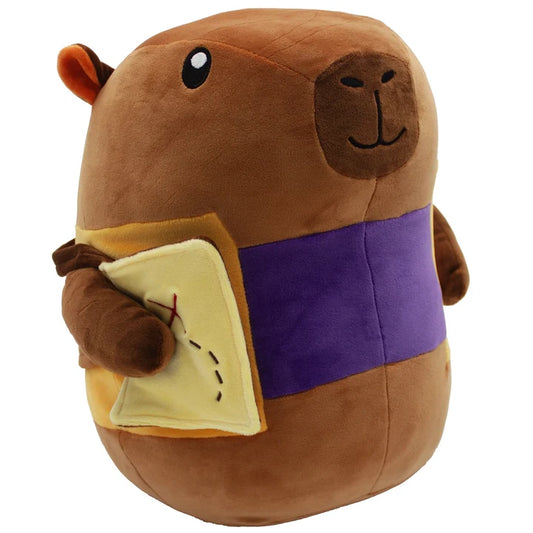 Cozy Critters Everdell Plush Coconut Capybara with a purple band and holding a yellow book.