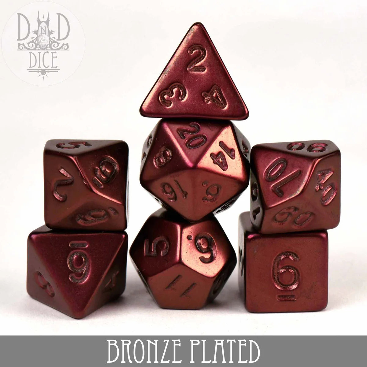 Bronze Plated 7-piece polyhedral dice set (D4–D20) stacked together.