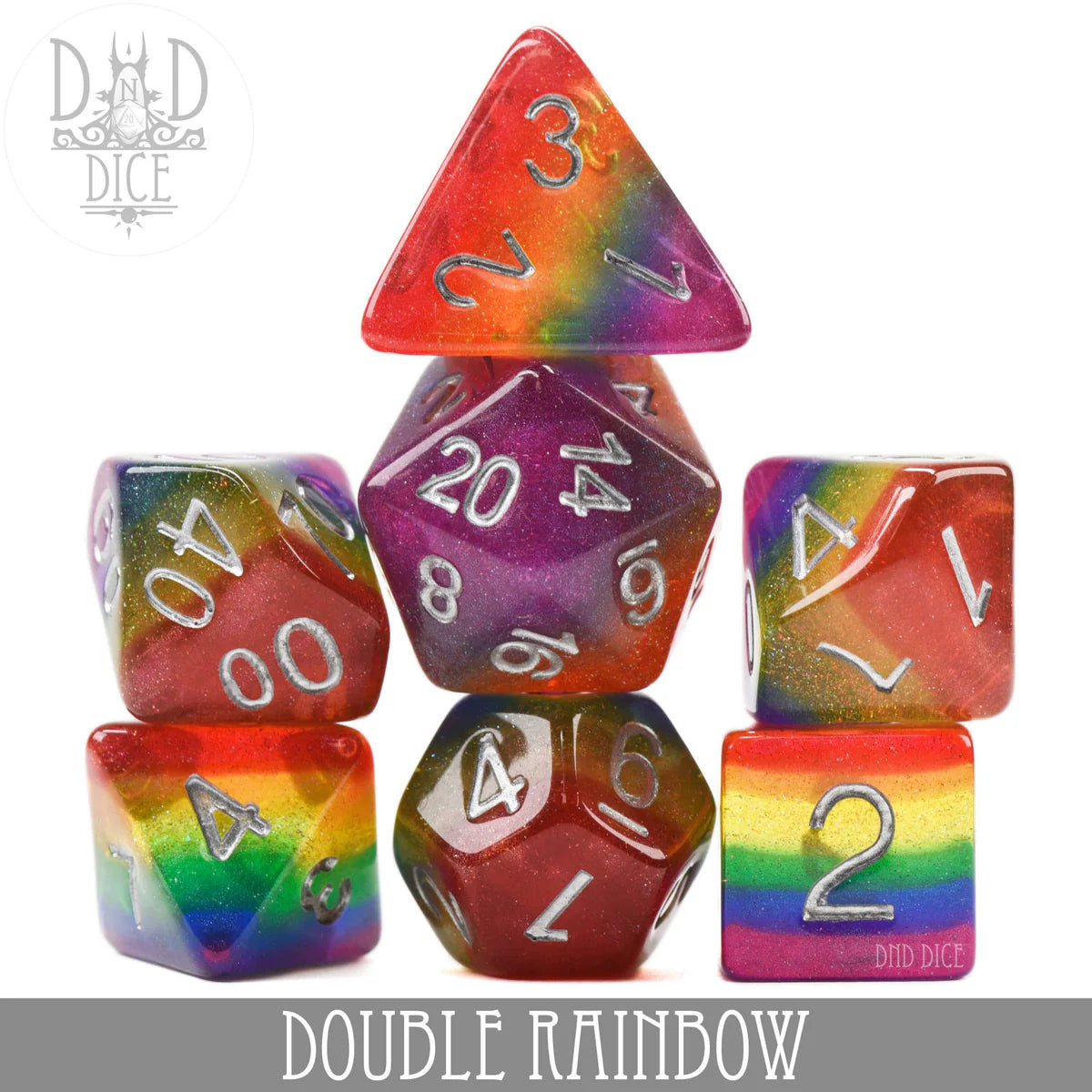 Double Rainbow 7-piece rainbow polyhedral dice set with white numbers. Dice are arranged in a pyramid formation.