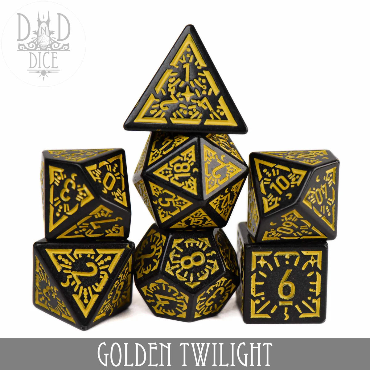Golden Twilight 7-piece black and gold acrylic polyhedral dice set with engraved numbers, arranged in a pyramid.