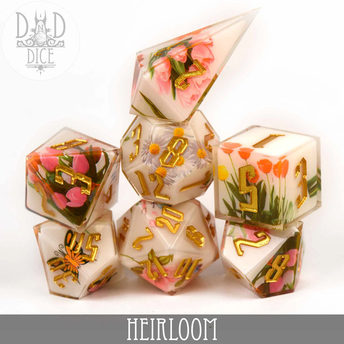 Heirloom (Handmade) 7-piece clear resin polyhedral dice set with gold numbers and embedded flowers.