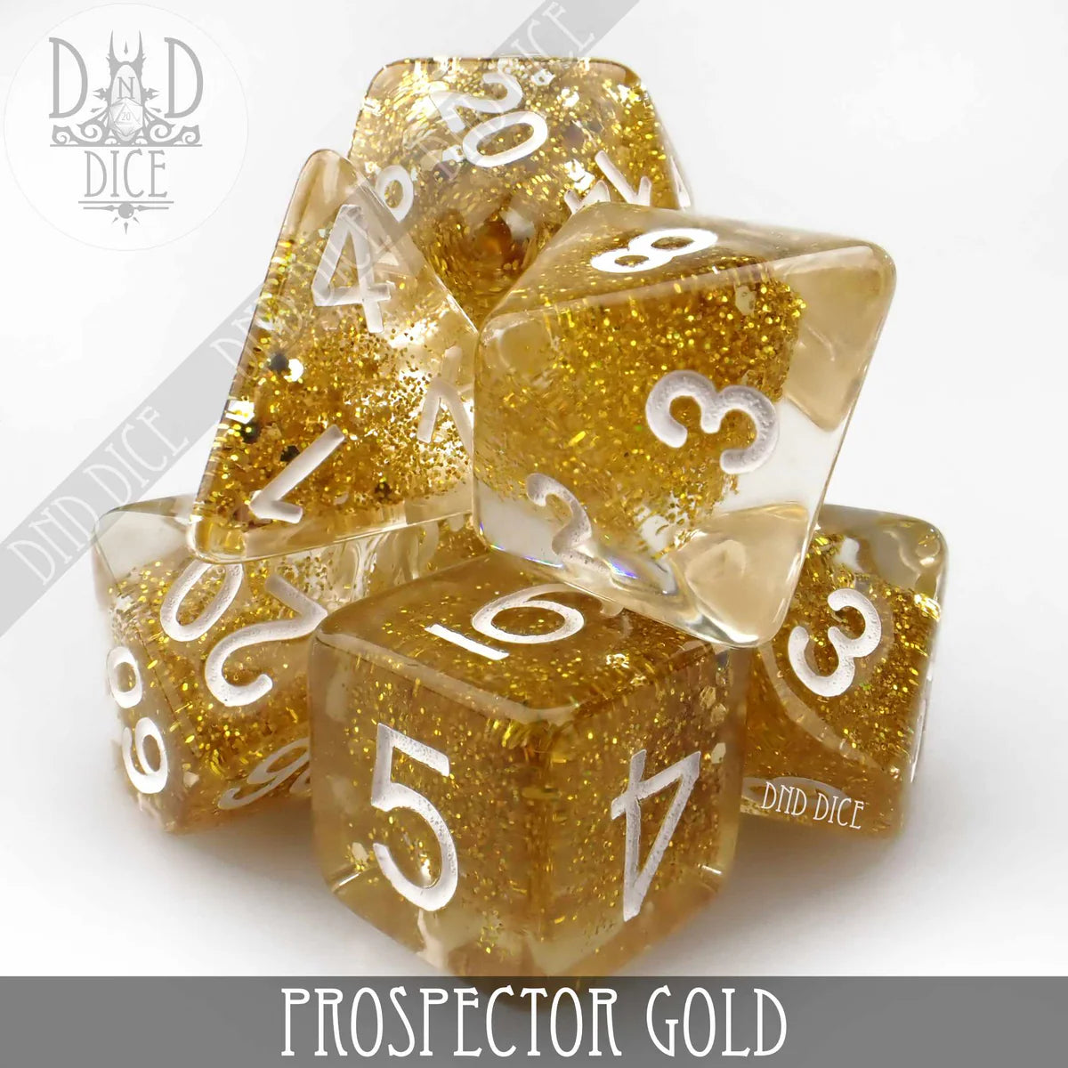 Prospector Gold set of 7 clear polyhedral resin dice with gold glitter and white numbers.