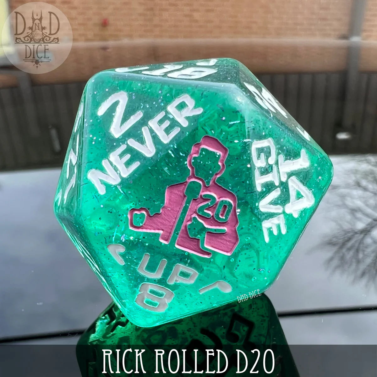 The Rick Rolled 34mm D20 green resin die featuring Never Gonna Give You Up text and a D20 silhouette.