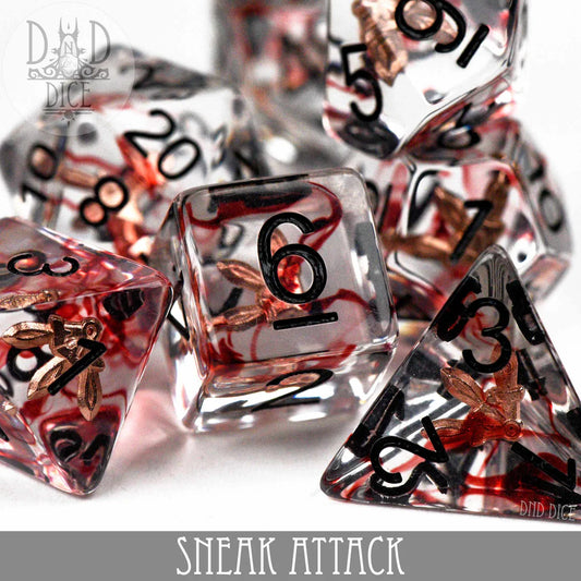 Sneak Attack 7-dice transparent resin set with black numbers and copper flecks.