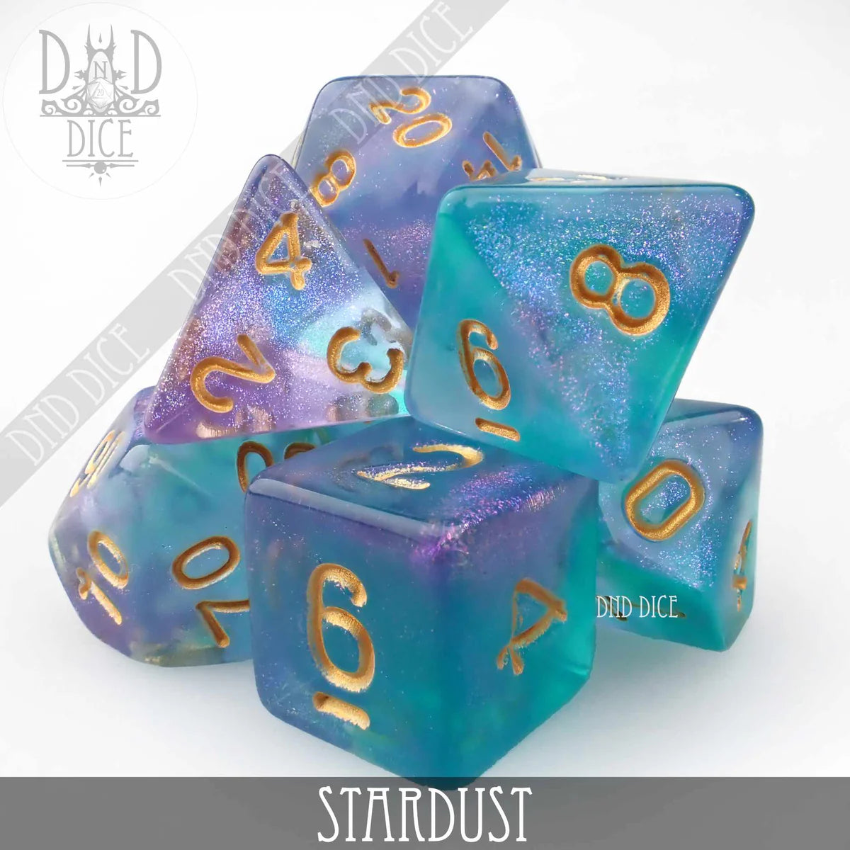 Stardust 7-dice set, blue and purple acrylic with gold numbers and embedded sparkles.