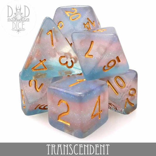 Transcendent 7-dice set in pastel pink and blue resin with gold numbers labeled at the bottom.