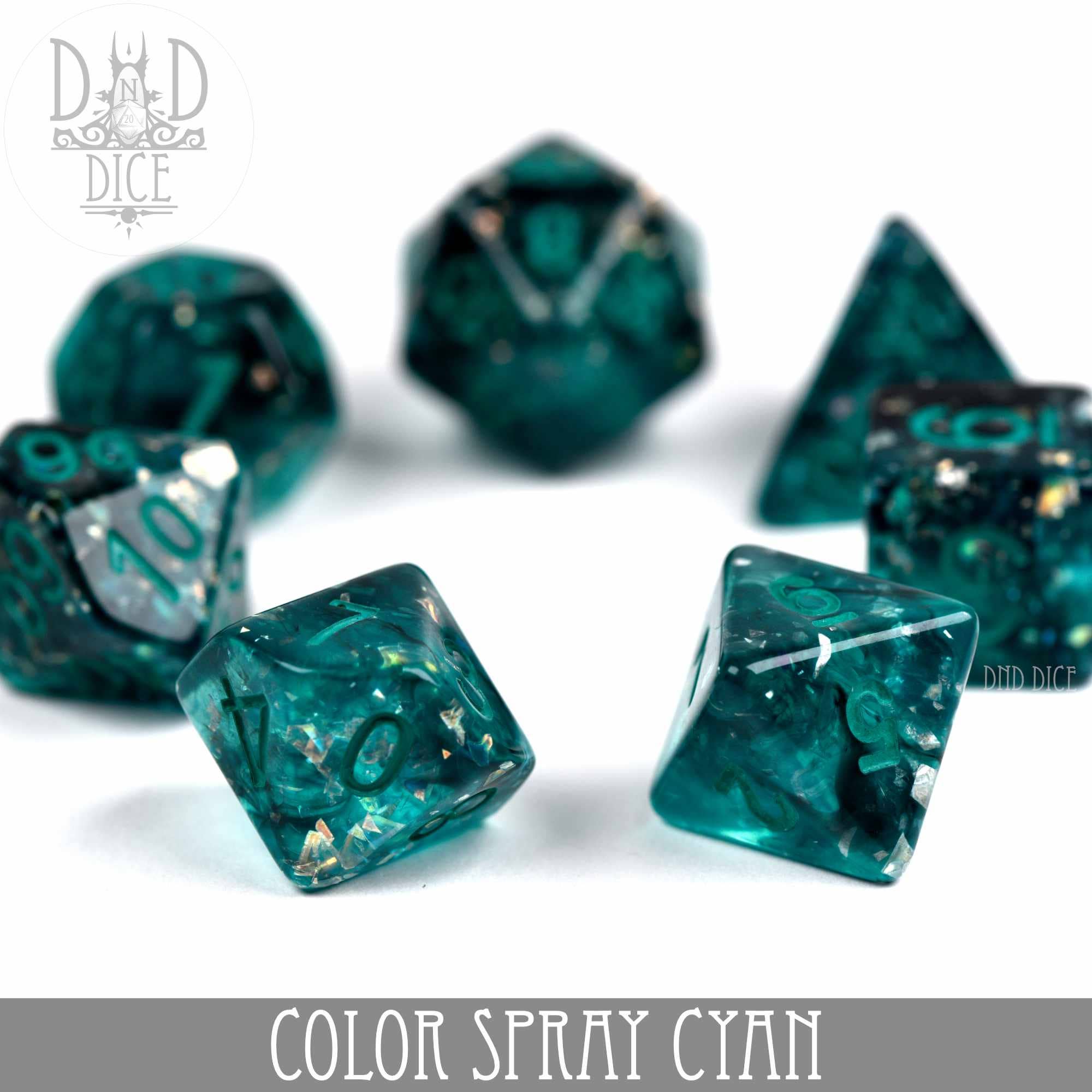Set of seven translucent cyan Color Spray Cyan dice with gold-white inclusions on a white background.