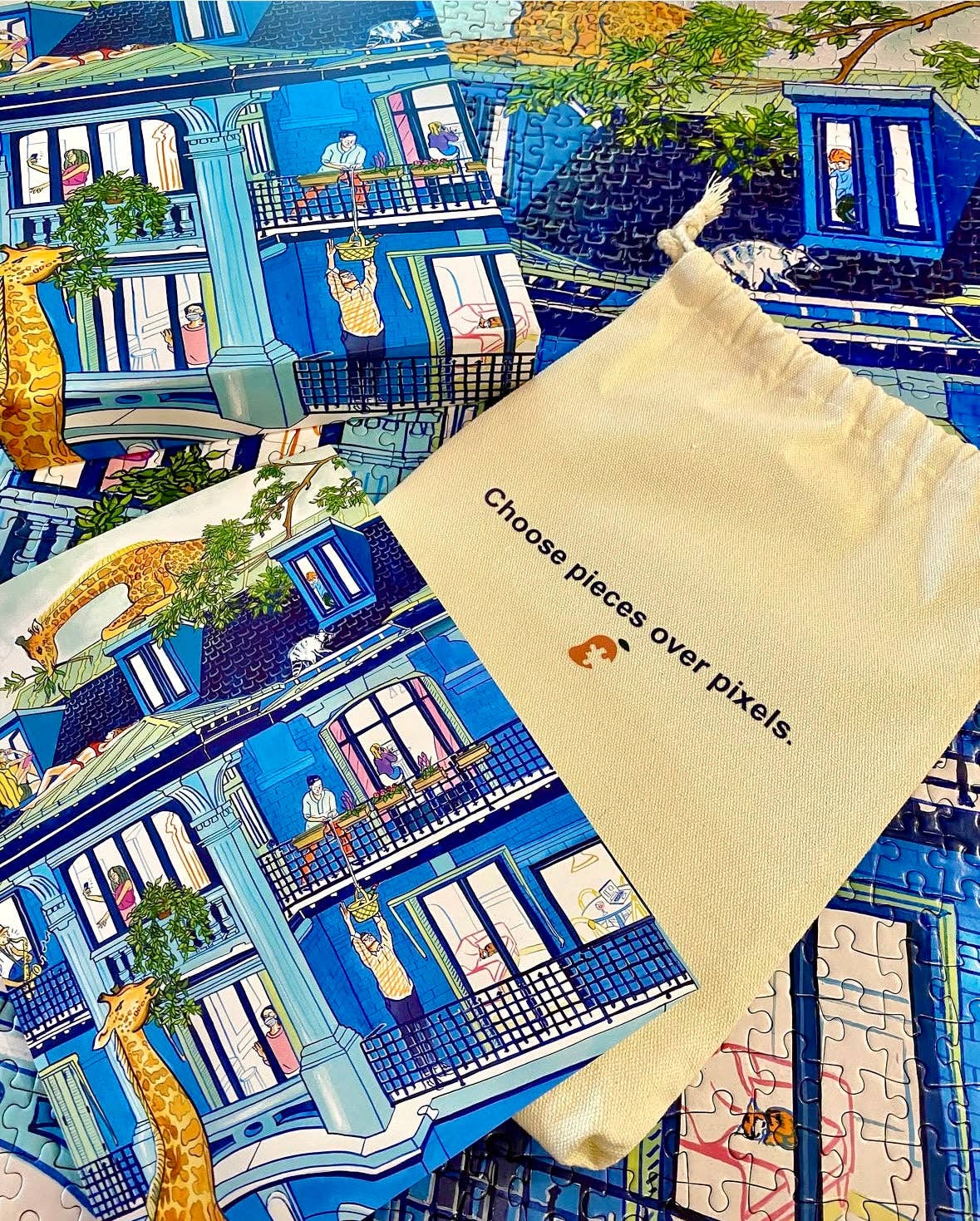City Culture 1000-piece puzzle for adults with Jules Monson’s artwork of a blue house and a giraffe.