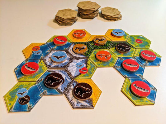 Cascadia board game tiles and animal tokens—bears, fish, and birds—displayed on a white surface.