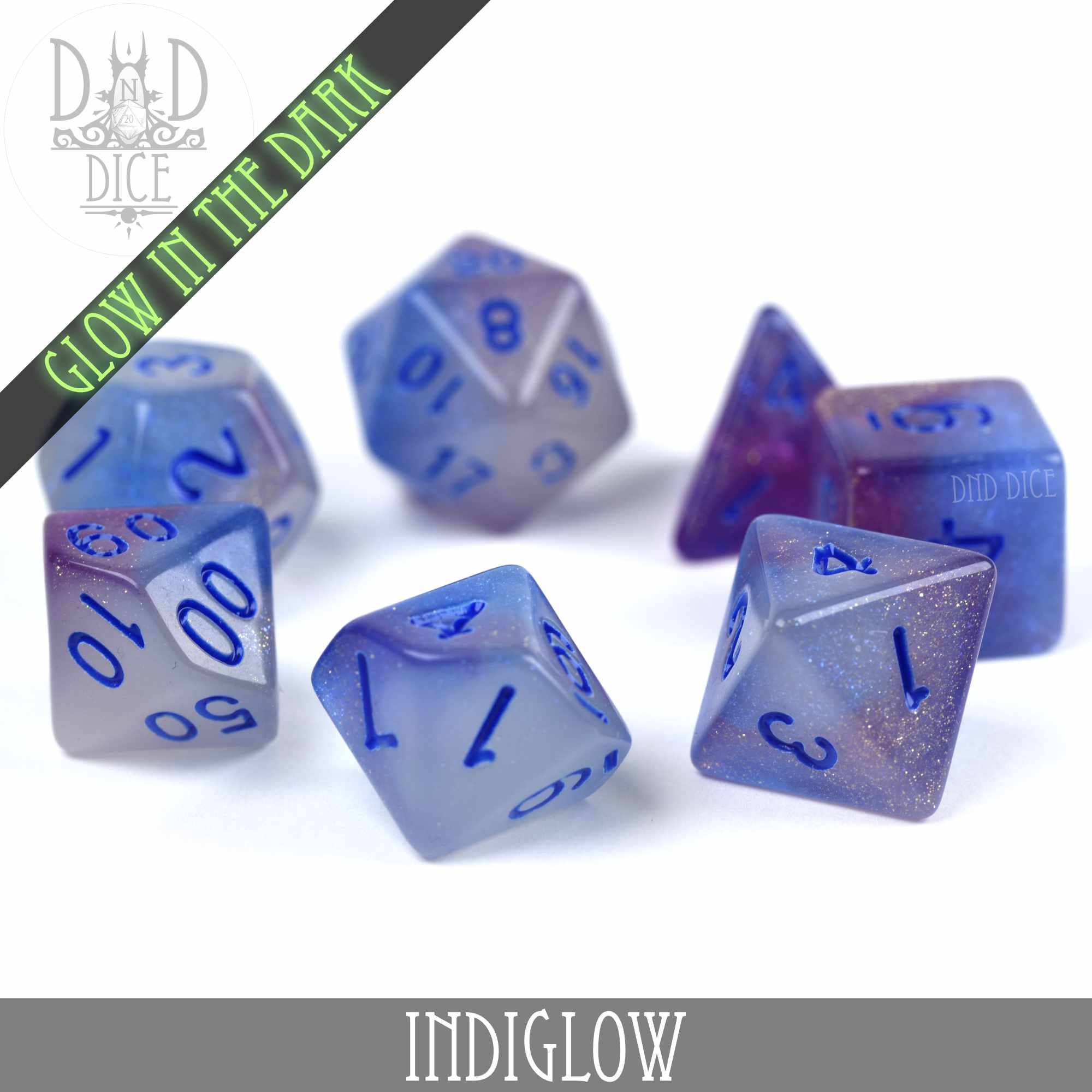 7-piece DND dice set in blue and purple resin with glitter, blue numbers, Indiglow glow-in-the-dark feature.