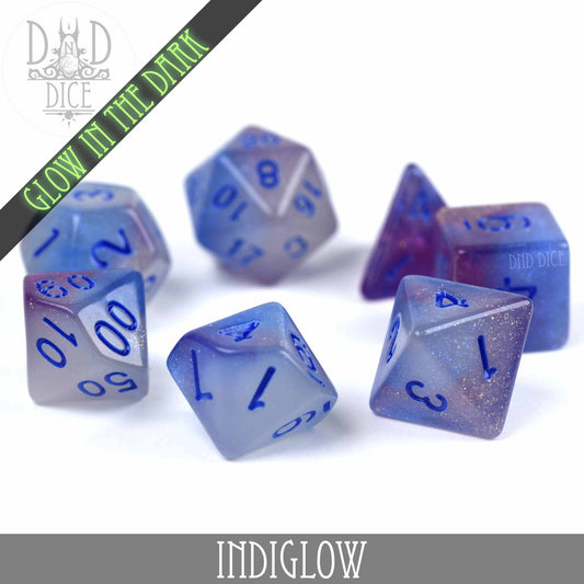 7-piece DND dice set in blue and purple resin with glitter, blue numbers, Indiglow glow-in-the-dark feature.