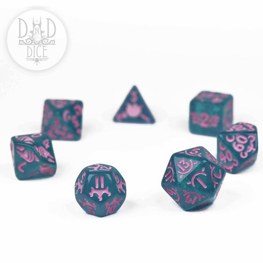 The Unicorn Princess 7-dice set in teal resin with pink numbers.