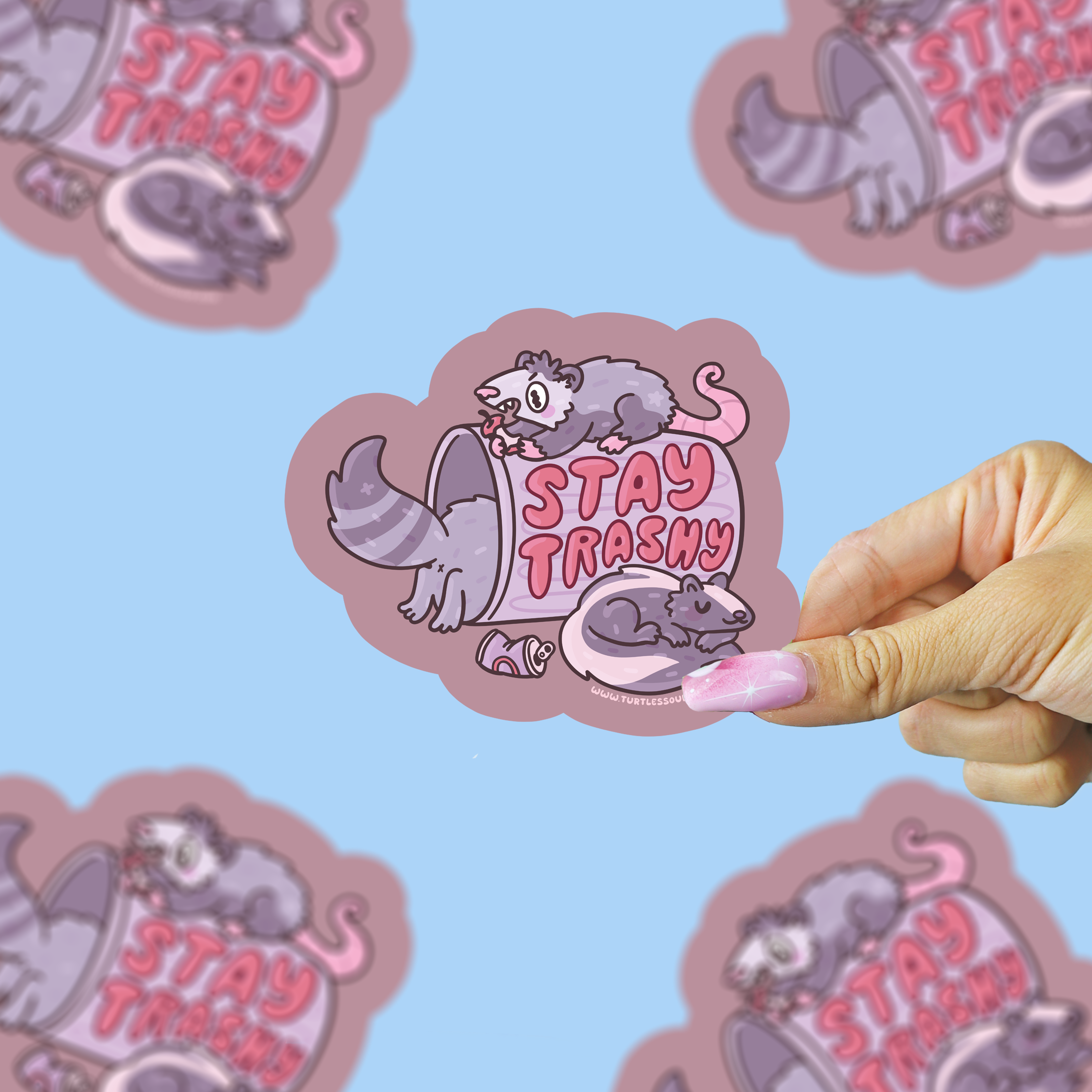 Stay Trashy NYC Street Animals vinyl sticker with cartoon opossums, trash can, and pink Stay Trashy text held in hand.