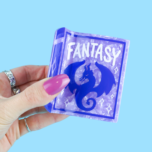Purple Fantasy Book and matching Bookish Magic Reader Hair Claw accessory held in a hand.
