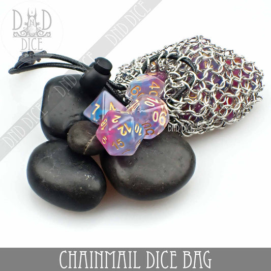 Chainmail bag containing purple dice, steel box, and black stones on a white background.