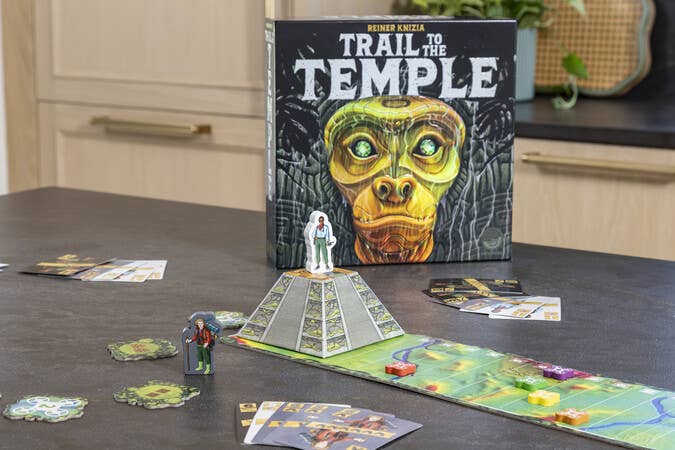 Trail To The Temple board game with 3D pyramid, cards, tokens, and standee figures.