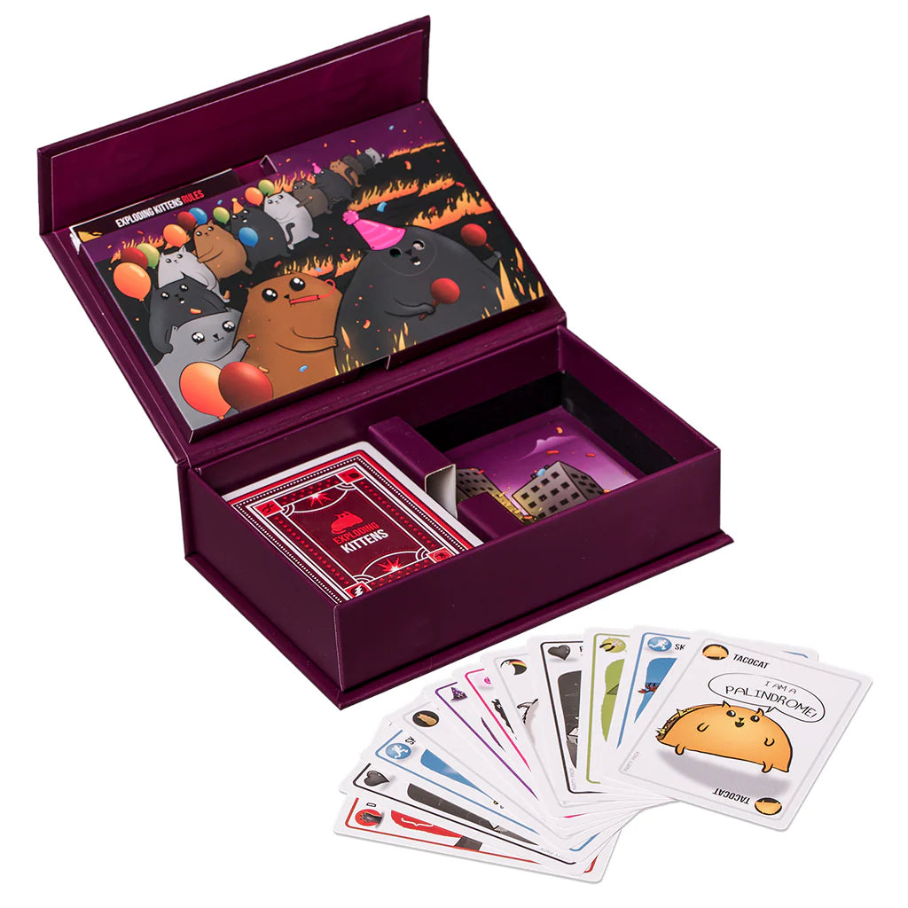 Exploding Kittens Party Pack in an open purple box with cards inside and additional cards fanned outside.
