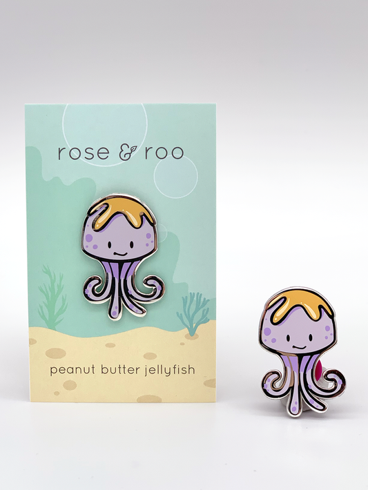 Peanut Butter Jellyfish Enamel Pin with matching card displaying “peanut butter jellyfish” text.