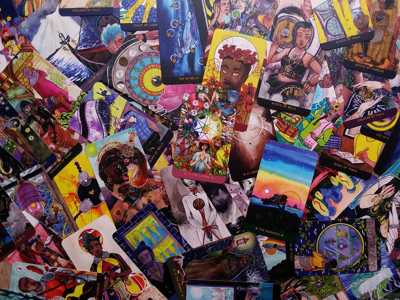 The Numinous Tarot by Cedar McCloud, a deck with diverse, colorful cards showing symbolic scenes and inclusive faces.