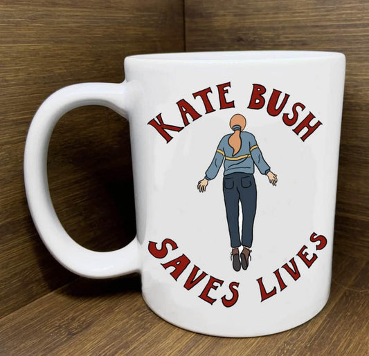 White mug with Kate Bush Saves Lives text and floating woman artwork inspired by Running Up That Hill.