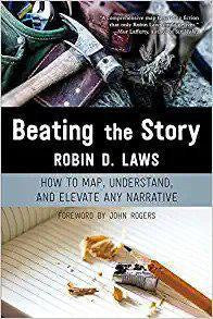 Beating the Story book cover with writing tools and a snapped pencil on a notebook.
