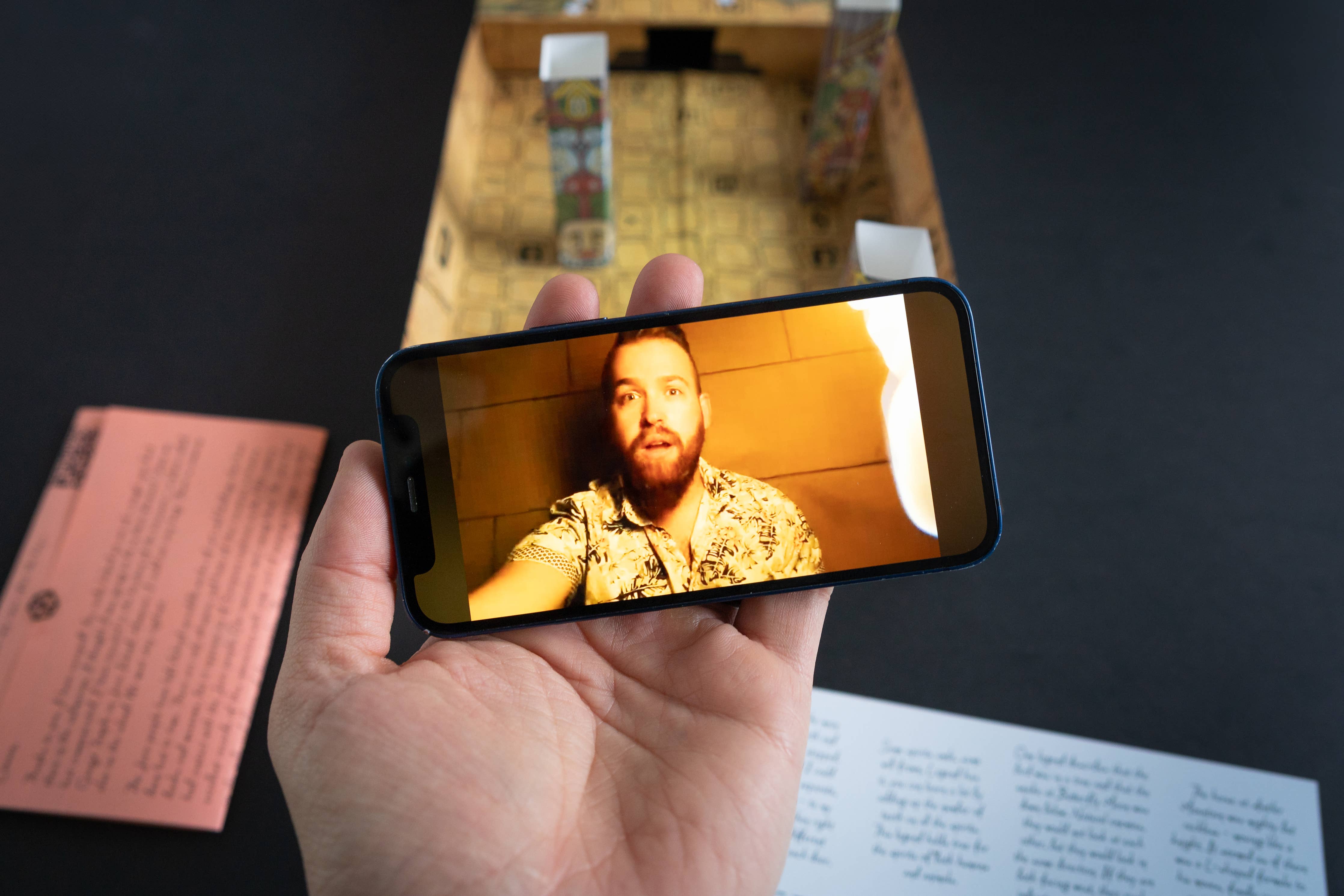 Man in Hawaiian shirt appears surprised while being filmed on a phone in Family Secrets Series Episode 3: Ancient Mysteries.