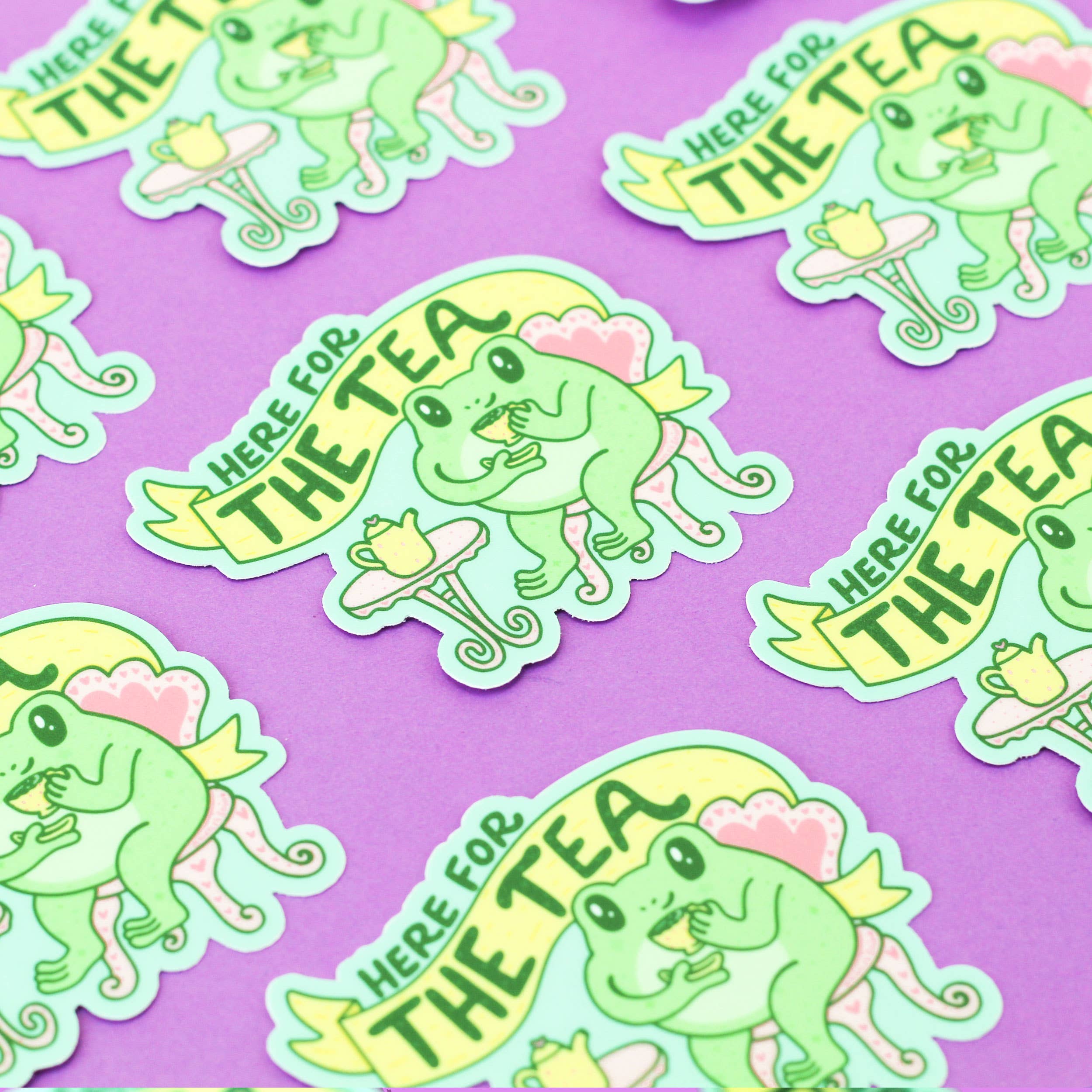 Here for the Tea Frog Gossip Laptop Decal Vinyl Stickers displayed on a purple background.