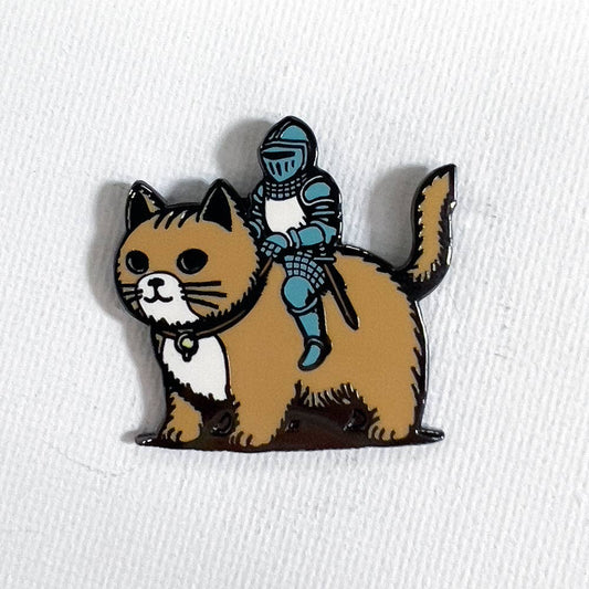 1.25-inch hard enamel Cat Knight pin featuring a brown cat with a white chest ridden by a knight in blue armor.