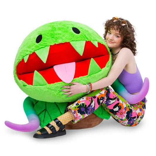 Massive Venus Fly Trap (33) plush, green with pointy teeth and large red mouth, held by a person.