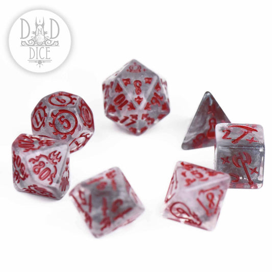Set of seven transparent resin polyhedral dice with red symbols from Enchanted Items.