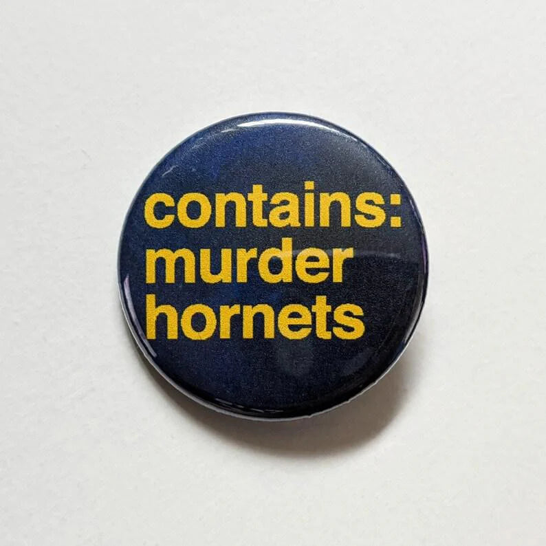 1.25-inch pin with yellow text Contains Murder Hornets—2020 Madness on a dark background.