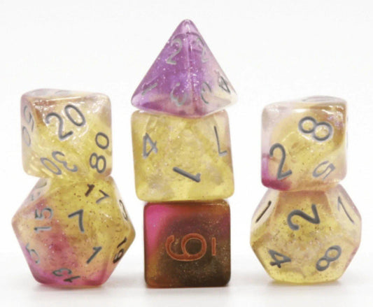 Three stacks of Dream Nebula RPG polyhedral dice in gold and purple on a white background.