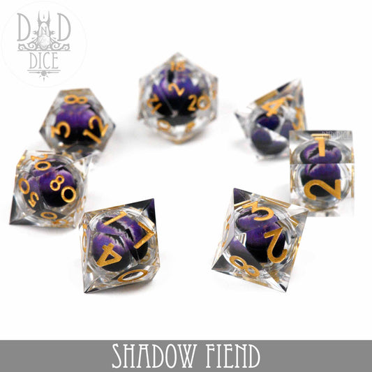 Shadow Fiend - Liquid Core dice set in clear resin with purple and black swirls, gold numbers, on white background.